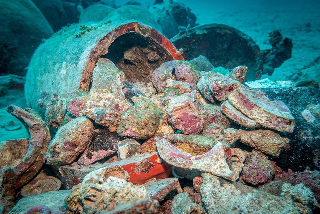 A broken ancient amphora that was filled with ballast stones. Ancient Roman wreck. Island of Šćedro, Croatia.